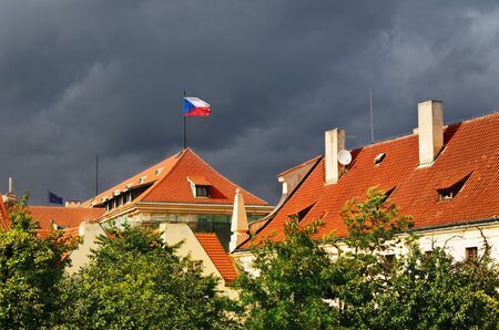 Tiled Roofs Of Prague With The Czech Republic Flagの写真素材