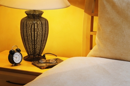 Close Up Fragment Of The  Bedroom With Reading Lamp And Alarm Clockの写真素材