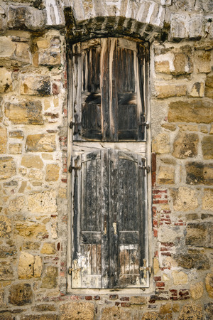 The Window Of An Old Building With Closed Shuttersの写真素材