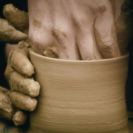 Hands Of The Potter In Process Of Creation Of A Bowlの写真素材