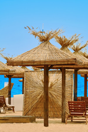 Beach Umbrellas and Lounge Chairs on the Sea Coastの写真素材