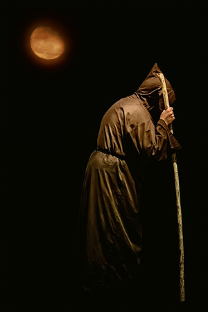 Monk with a Stick at Nightの写真素材