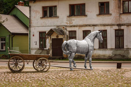 Jekabpils, Latvia - June 16, 2020: Fragment of Sculpture "Horse with a carriage" (author - Gaits Burvis) on the historic Wednesday market place in Jekabpils, Latviaのeditorial素材