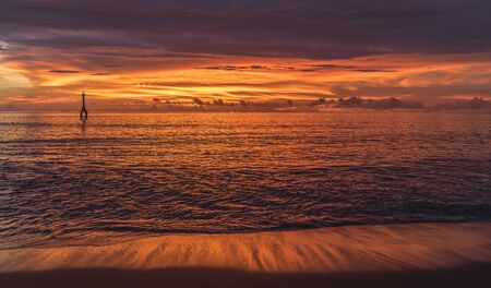 Bright vivid pink and red sunset in the evening at the beach near Padang, West Sumatra, Indonesia surf spot but no wavesの写真素材