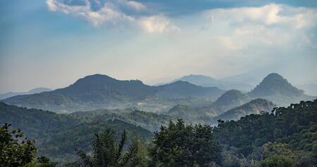 Beautiful hills covered in haze because of forest fires spotted in rural West Java, Indonesiaの写真素材