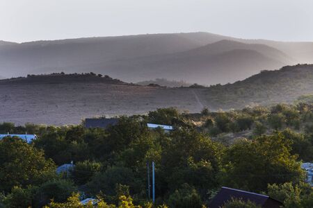 sunlight illuminates the mist on the mountains in the early morningの写真素材