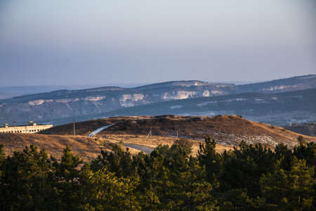 sunlight illuminates mountain peaks in the early morningの写真素材