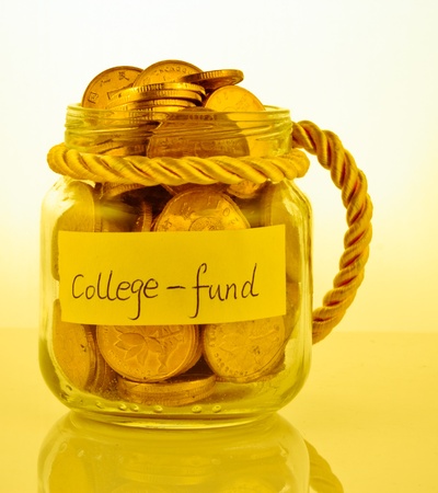 A lot of money in a glass bottle labeled  College fundの写真素材