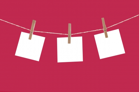 Blank paper cards hanging on clothespinsの写真素材