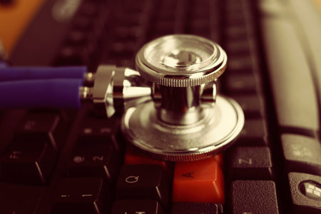 Stethoscope and keyboard illustrating concept of digital securityの写真素材