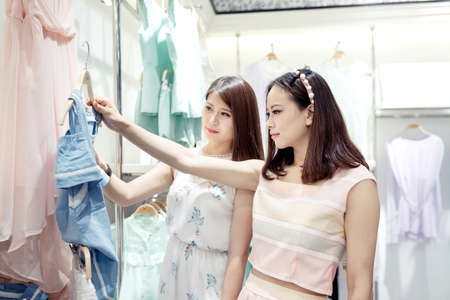 Beautiful young women shopping in a clothing storeのeditorial素材