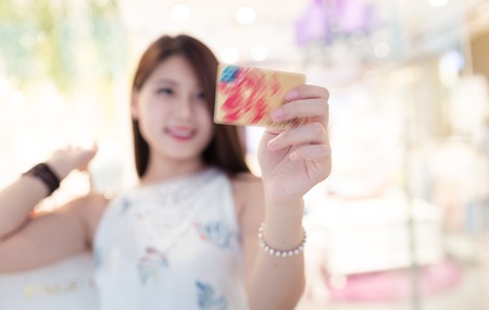 Beautiful young women shopping in a clothing storeの写真素材
