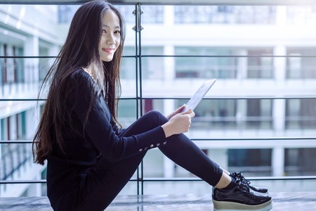 Girl playing the Tablet PCの写真素材