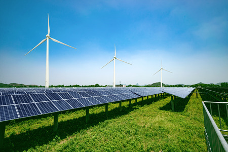 solar panels and wind generators under blue sky on sunsetの写真素材