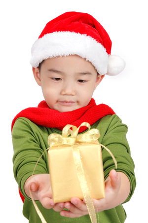 Boy holding a Christmas gift isolated on white backgroundの写真素材