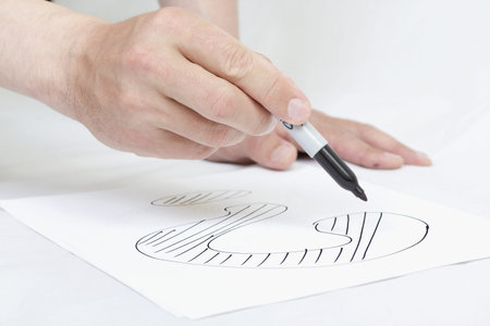 Hand drawing question markl on white paper.