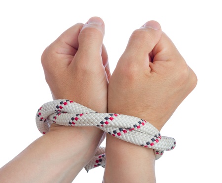 Caucasian man wrists bounded together with rope の写真素材