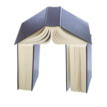 Stack of books shaoed as house with walls and roof の写真素材