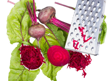 Stainless steel grater and grated beet isolated on white background.
