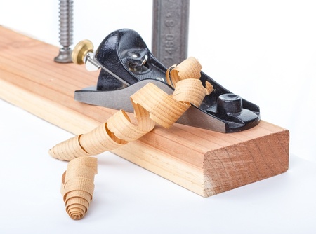 Wood planer and redwood plank isolated on white.の写真素材