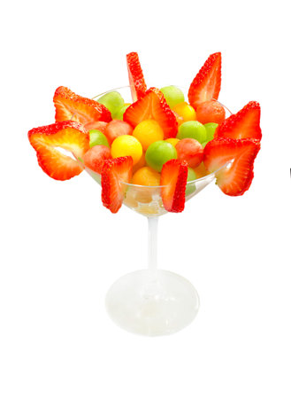 ball shaped fruit salad served in martini glass.の写真素材