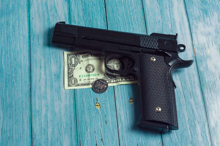 Gun, dollar and Ukrainian coinの写真素材