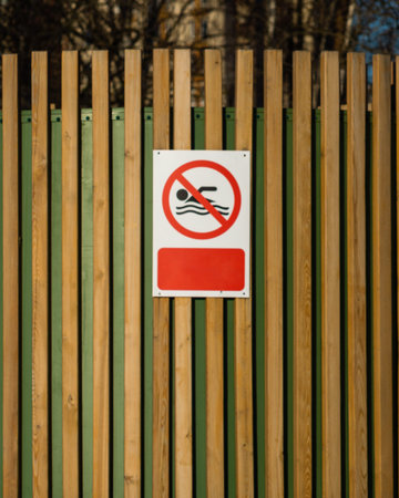 No swimming sign on a wooden fenceの写真素材