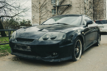 Black sports car parked with flat tires
