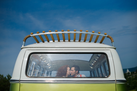 Young couple kissing in the carの写真素材