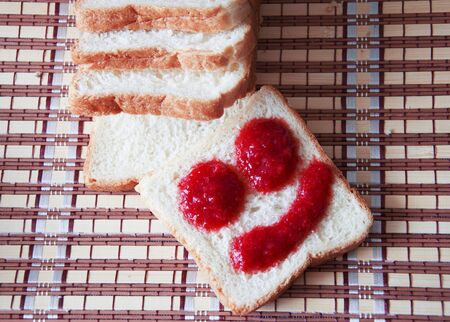 toasters with strawberry jam for breakfast on tableの写真素材