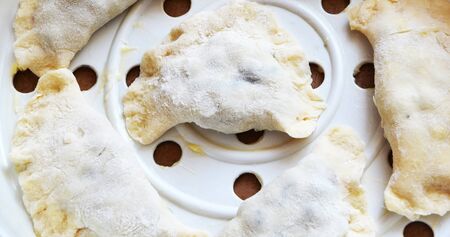 Cooking Vareniki, dumplings, pierogi before boiling, traditional Ukrainian foodの写真素材