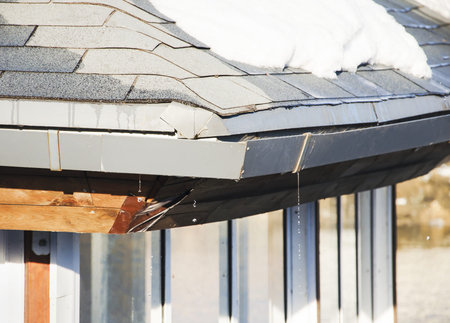 Thaw, melting snow on the roofの写真素材