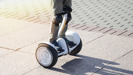 boy riding a hoverboard in the squareの写真素材
