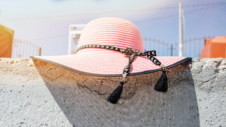 pink straw sun hat on blurry background