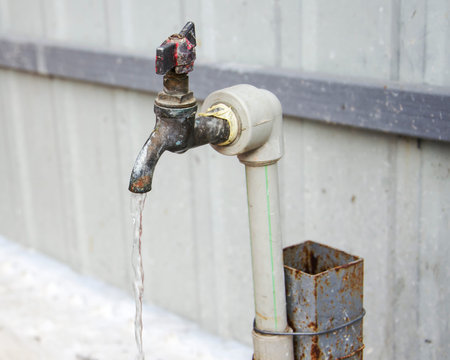 old rusty water tap on the street