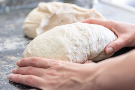 woman hands kneading homemade bread at home