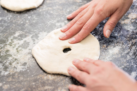 woman's hands making fried cakes (Argentinas)