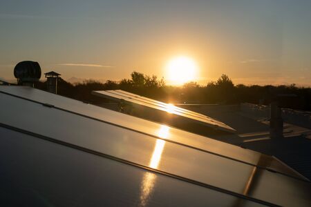 Solar energy panels against sunset skyの写真素材