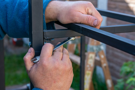 Hands Holding a Wrench and Tighten