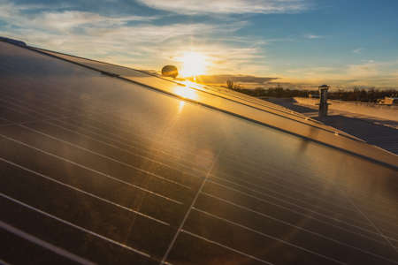 Solar panels with water spray, at sunset.の写真素材