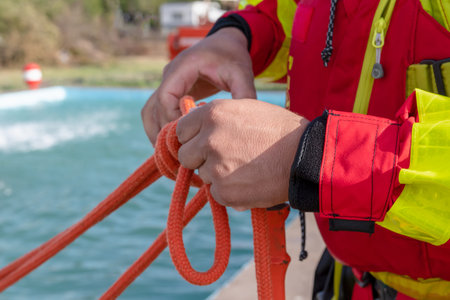 firefighter hands tying rope knot