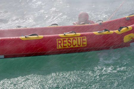 San Rafael, Argentina, November 6, 2020: firefighters in water rescue drill, using canoe and special suitsのeditorial素材
