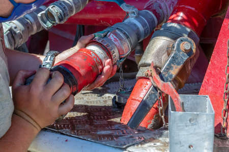 Fire staff Connect the hose to put out the fire from the fire truck.の写真素材
