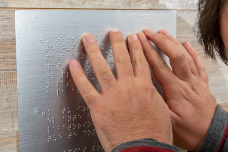 Close up of male hand reading braille textの写真素材