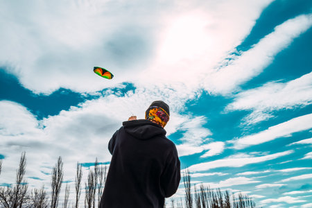 boy flying big kite on windy day