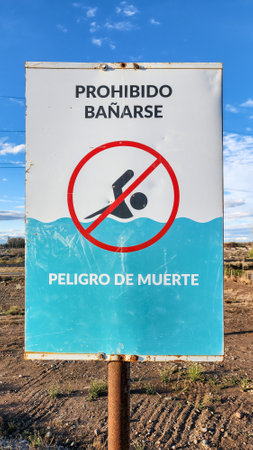 Poster prohibiting bathing, with text in Spanish. Danger of death.の写真素材