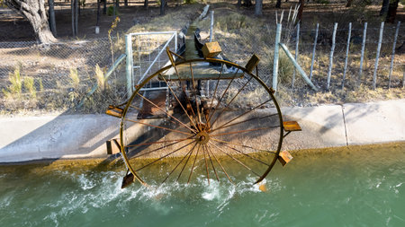 Ferris wheel drawing water from the river to irrigate.の写真素材