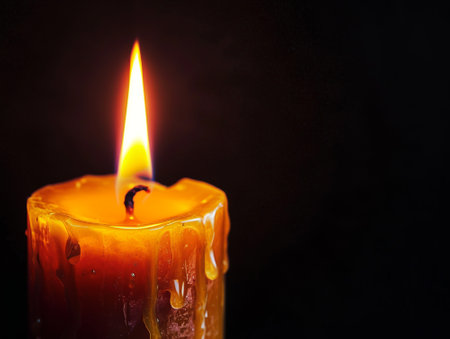 Closeup of candle flame on black background.の素材