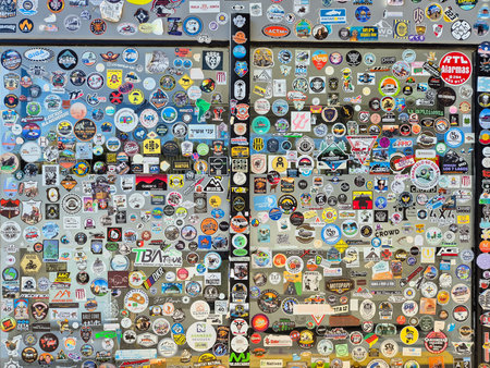 A wall covered in stickers of various shapes and sizes of travelers recording their passage. Patagonia Argentina.の写真素材