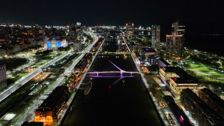 Urban landscape of Puerto Madero at sunset, with the city of Buenos Aires in the background. Aerial night view.の写真素材